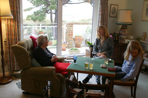 My Grandmother's sitting room with a view to the beach on Hayling Island and the card table where she has polished her bridge playing skills to be feared still along the south coast. My sister Claire in shot with eldest Loviisa